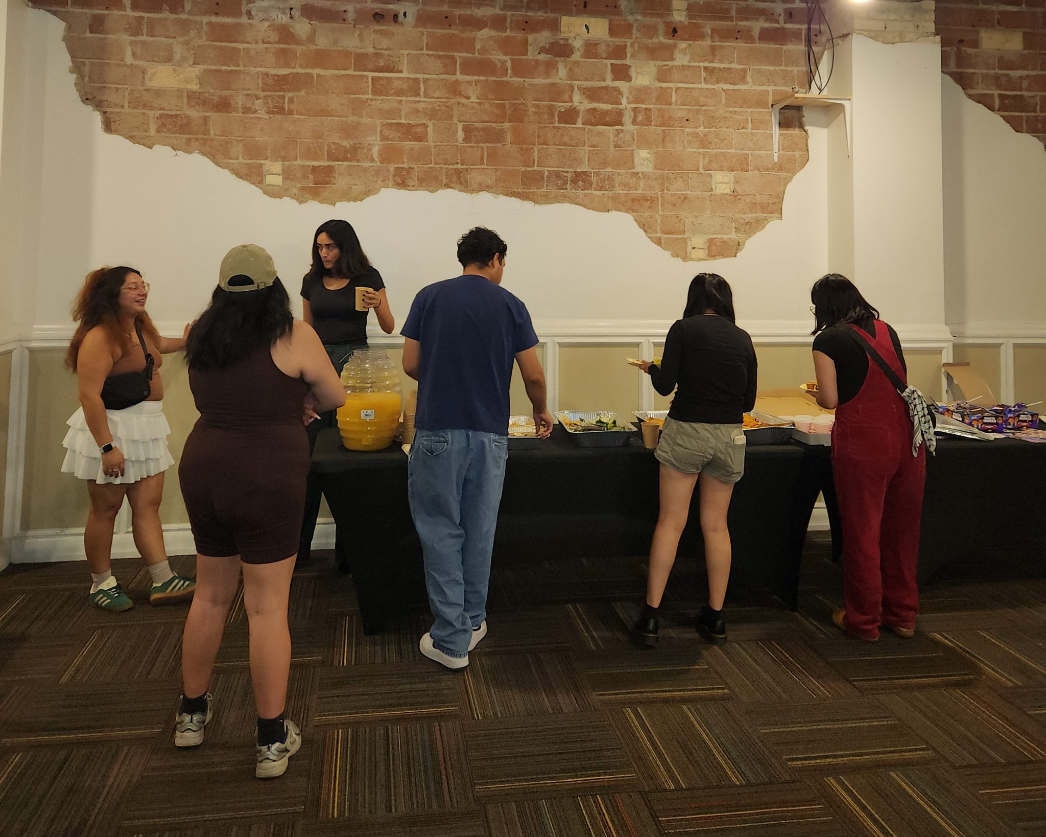 Several people gathered around a table during an event