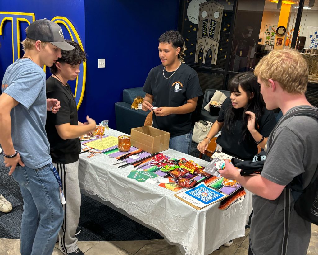 Several people gathered around a table during an event.