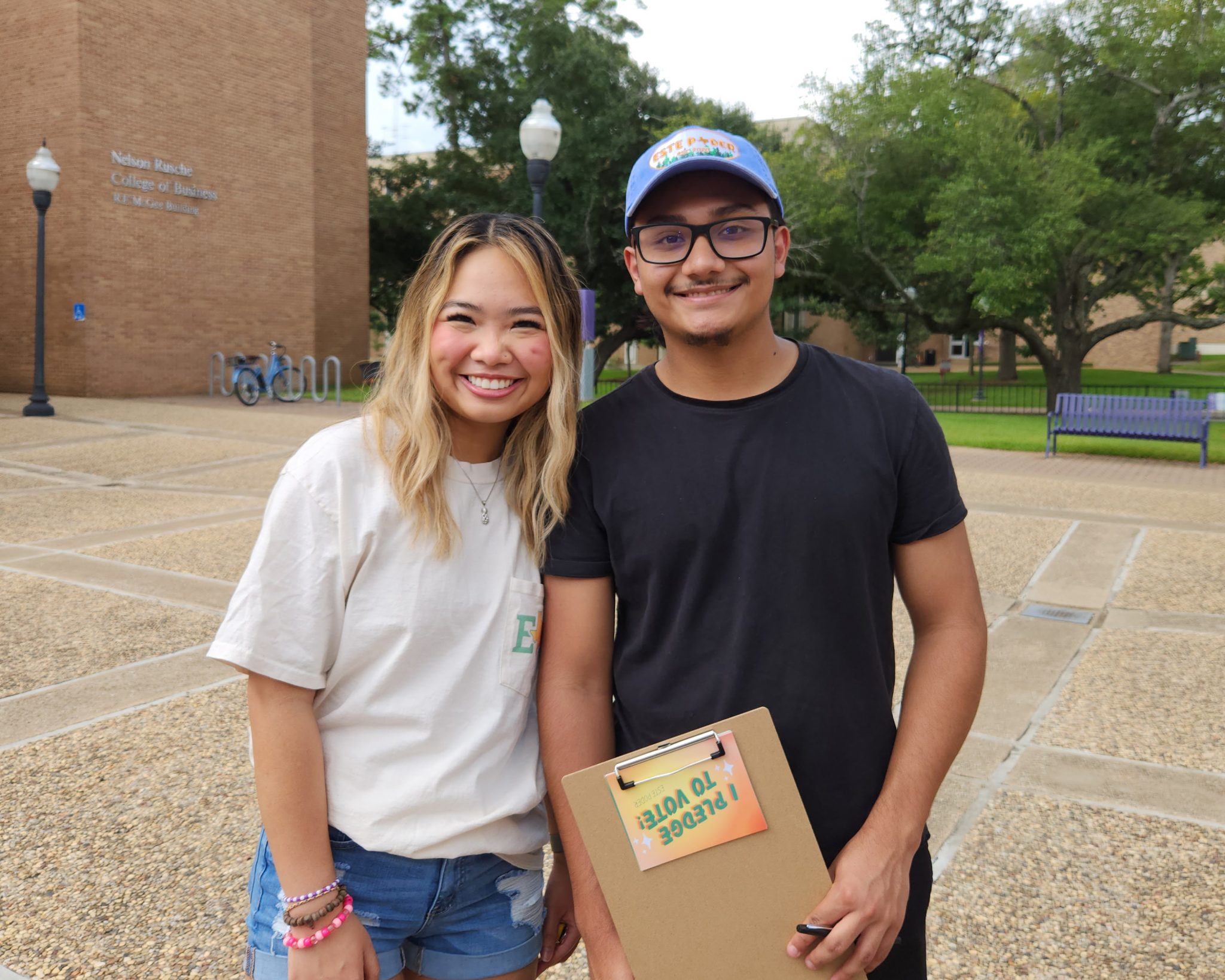 A young man and woman stand together.